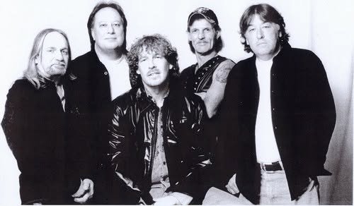 Black and white group portrait of five musicians