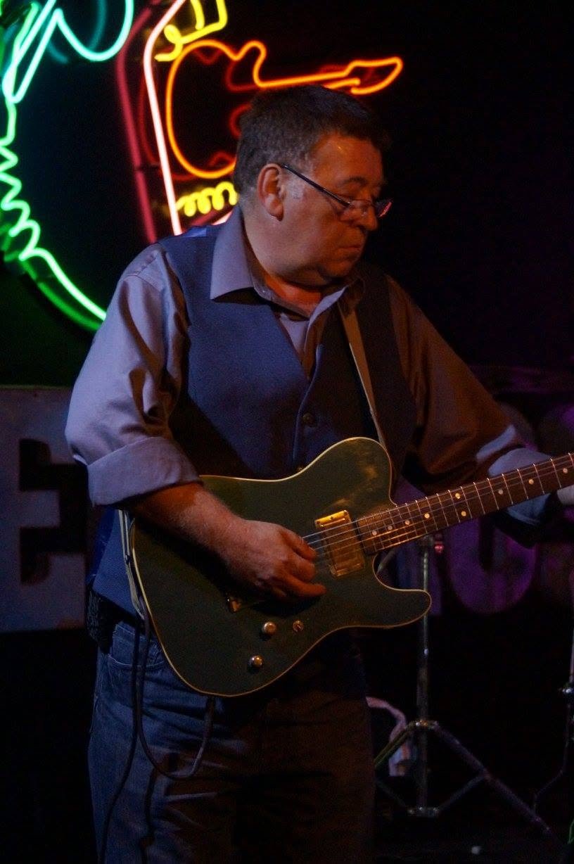 Guitar performance beneath colorful neon lights